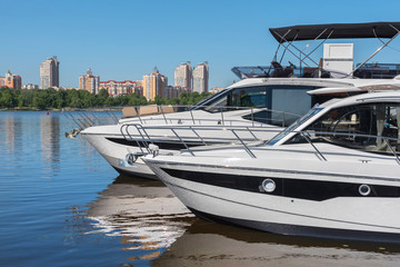 Fototapeta premium Kiev, Ukraine - June 01, 2018 : A marina, a pool with a dock with moorings and supplies for yachts and small boats, against the backdrop of the city