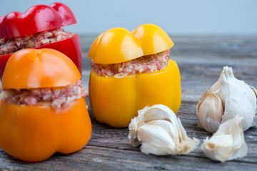 Fototapeta na wymiar filled pepper,garlic and onion on wooden ground