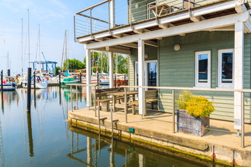 Obraz premium Holiday house terrace on water in Lauterbach port, Ruegen island, Baltic Sea, Germany