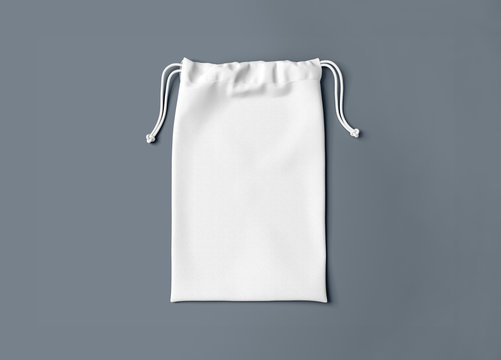 White drawstring bag on background. Fabric cotton small bag. Isolated pouch.