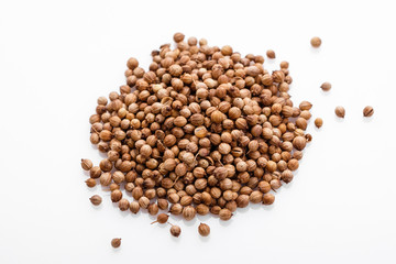 fragrant coriander seeds on a white background