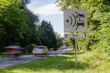 Speed limit speed camera sign close to the road