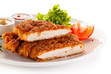 Fried pork chop and vegetable salad on white background