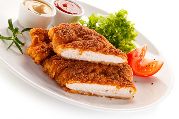 Fried pork chop and vegetable salad on white background