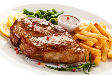 Grilled steak, French fries and vegetables