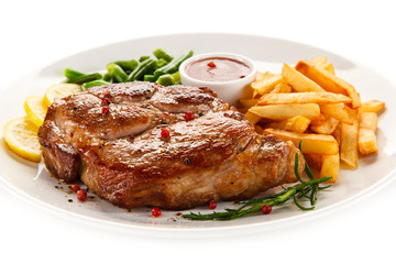 Grilled steak, French fries and vegetables