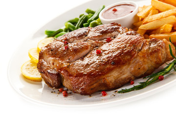 Grilled steak, French fries and vegetables