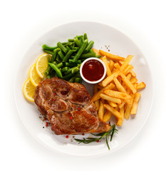 Grilled steak, French fries and vegetables