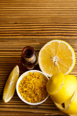 Lemon essential oil on a wooden background
