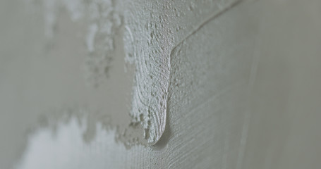 closeup applying decorative concrete plaster on the wall