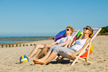 Woman and man relaxing on beach