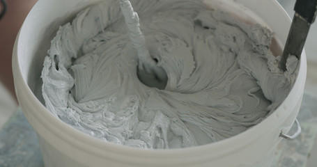 closeup mixing gray decorative concrete plaster