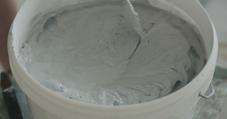 closeup mixing gray decorative concrete plaster