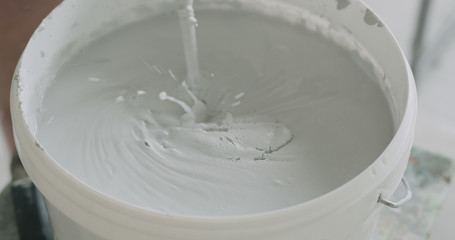 closeup mixing gray decorative concrete plaster