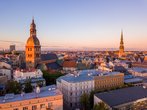 Magical sunset aerial view over Riga old town during "Jani" and "Ligo" celebration in Latvia. People dancing and singing by the river.