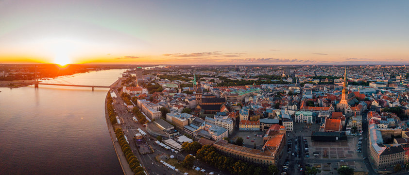 Magical sunset aerial view over Riga old town during "Jani" and "Ligo" celebration in Latvia. People dancing and singing by the river.
