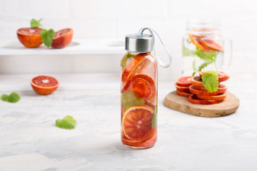 Detox infused water flavored with bloody orange and mint. Healthy refreshing beverage.