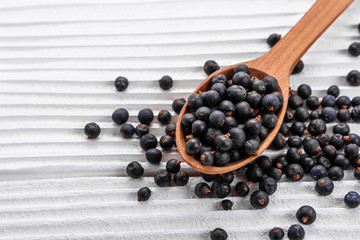 dried juniper berries on a white background