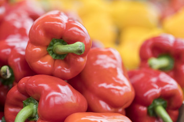 Red pepper on street market shelf. Red bell pepper pattern. Background of fresh sweet heap of red pepper paprica closeup vegetable shop. Red bulgarian paprika harvest pile from organic farm for sale.