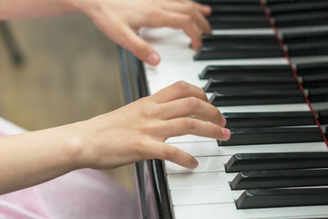 Obraz premium children's hands are playing the piano. Child's hand on piano keys.