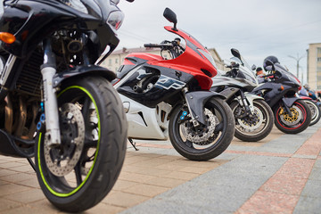 Motorcycles in a row, on the city square