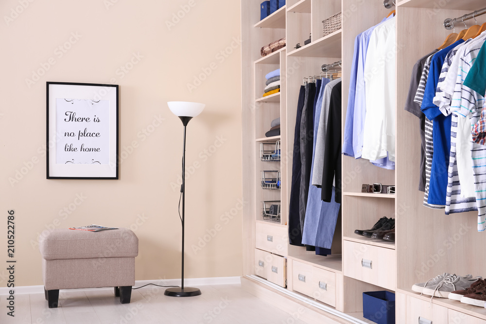 Poster Room interior with wardrobe and stylish ottoman chair