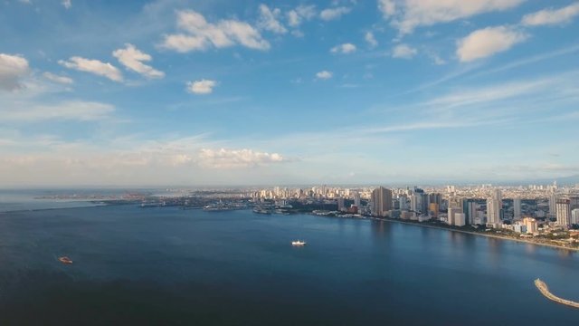 Aerial view skyline of Manila city. Fly over city with skyscrapers and buildings. Aerial skyline of Manila . Modern city by sea, highway, cars, skyscrapers, shopping malls. Aerial footage Makati