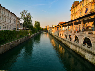 Romantic Ljubljana's city center: river Ljubljanica, Triple Bridge (Tromostovje), Preseren square and Franciscan Church of the Annunciation; Ljubljana, Slovenia, Europe.