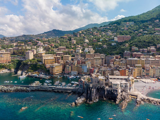 Fototapeta na wymiar Aerial View of Camogli town in Liguria, Italy. Scenic Mediterranean riviera coast. Historical Old Town Camogli with colorful houses and sand beach at beautiful coast of Italy.
