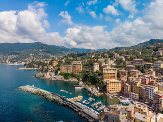 Aerial View of Camogli town in Liguria, Italy. Scenic Mediterranean riviera coast. Historical Old Town Camogli with colorful houses and sand beach at beautiful coast of Italy.