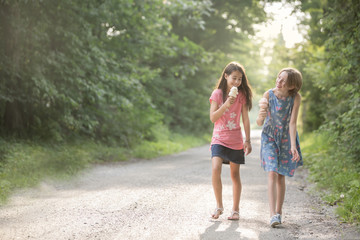 Two happy girls with ice cream cones on a perfect summer day