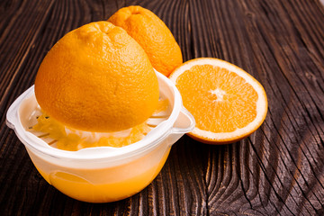 oranges and juice on a wooden background