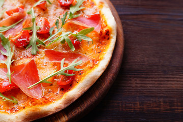 Restaurant, food delivery, pizzeria menu concept. Appetizing ham pizza with arugula flat lay with copy space. Delicious classical recipe, traditional Italian snack