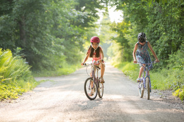 Two Friends Biking on a Dirt Road