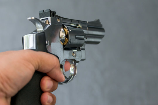 Man Holding Gun Revolver Pistol In Shooting