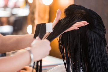 Hair care in modern spa salon. Close up of beautiful woman hair. Mask, balm