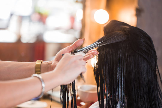 Beautician Apply Balm And Conditioner To The Hair Of A Woman.