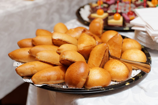 Stuffed buns and desserts on catering table