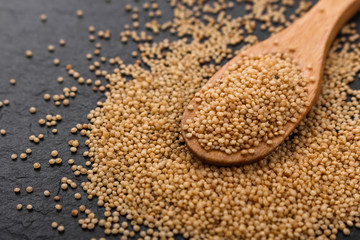 fresh amaranth grains on a rustic background