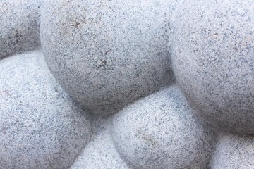 An interesting work of stone in the form of a cloud or a large number of balls. It reminds porous chocolate of large sizes.