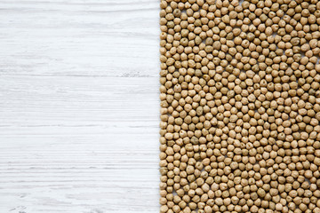 Dried chick peas on white wooden background, top view. Copy space.