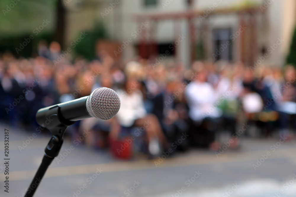 Wall mural microphone and stand in front of graduation ceremony audience against a background of auditorium - Wall murals