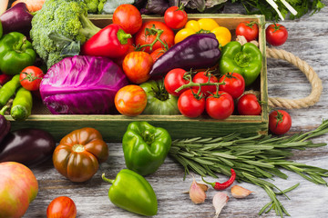 Set of different fresh raw colorful vegetables in the wooden tray