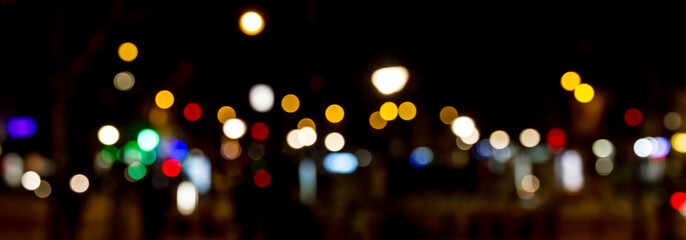Bokeh traffic light at night in the street of a big city