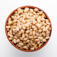 peeled pine nuts on a white acrylic background