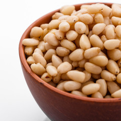 peeled pine nuts on a white acrylic background