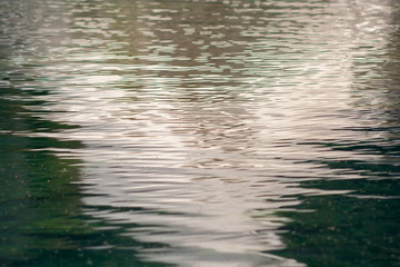 Water mirror in the lake. Small waves forming in a mountain lake.
