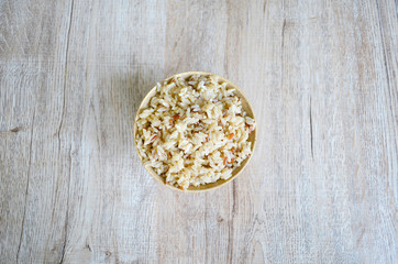 Brown rice bowl, on wooden background