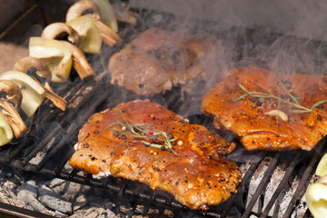 meat with  herbs grilling on barbecue