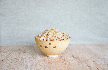 brown rice in bowl Japanese style, on  wooden background, food concept